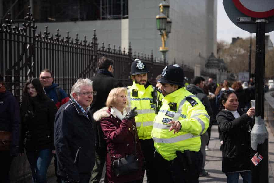 London Police talking with and helping eldery couple