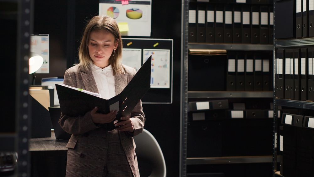 Female private detective conducting investigation in office