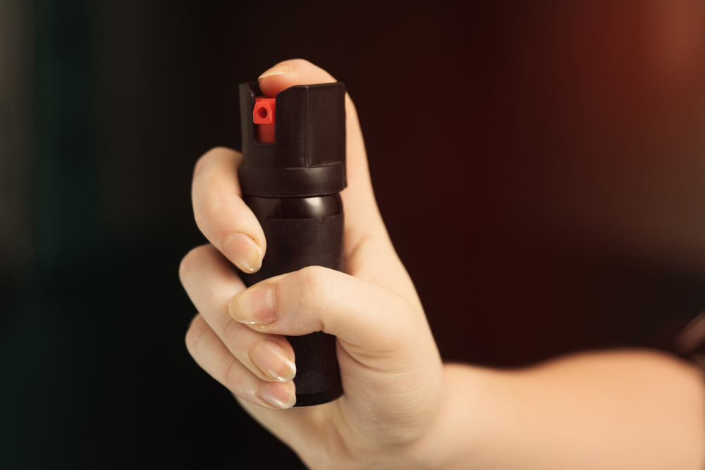 Girl hand is protected by pepper spray