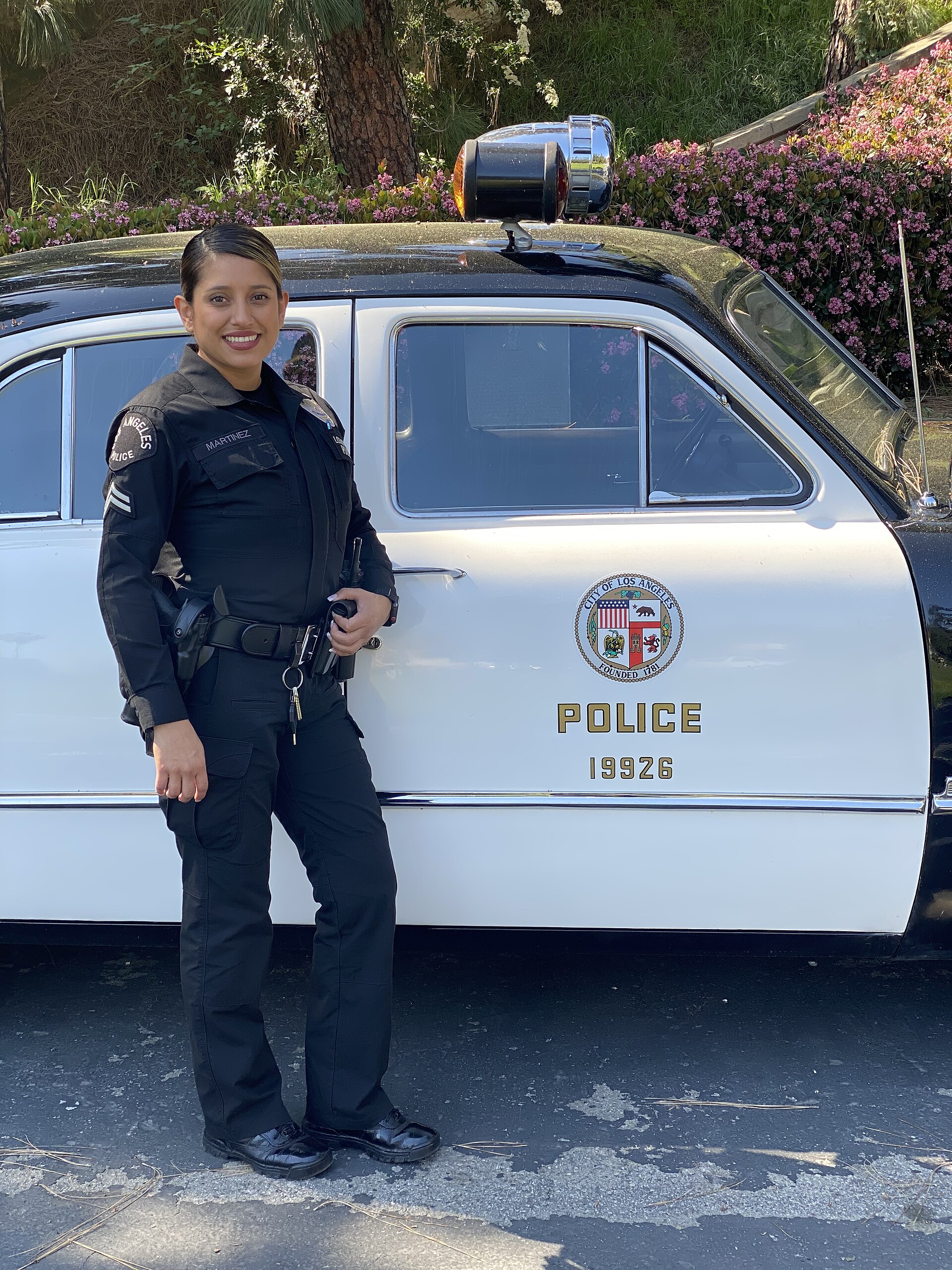 Why Are Police Called 12? The Meaning Behind the Slang 1 LAPD officer with a vintage patrol car