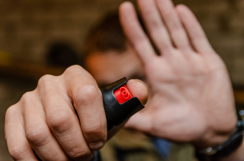 Man holding pepper spray for self defense