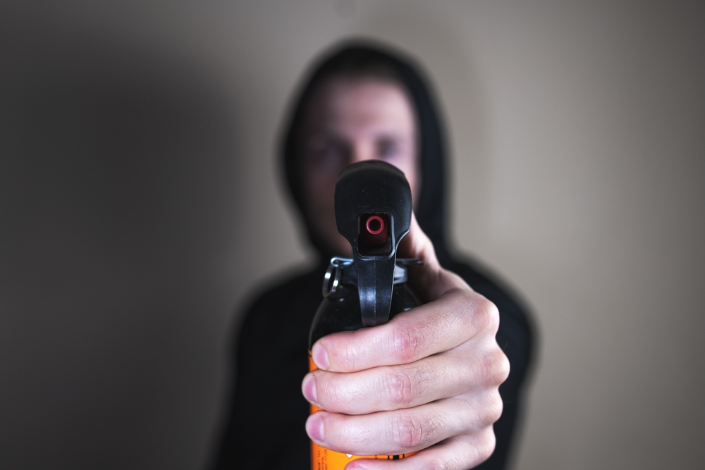 Man with pepper spray gun in his hands