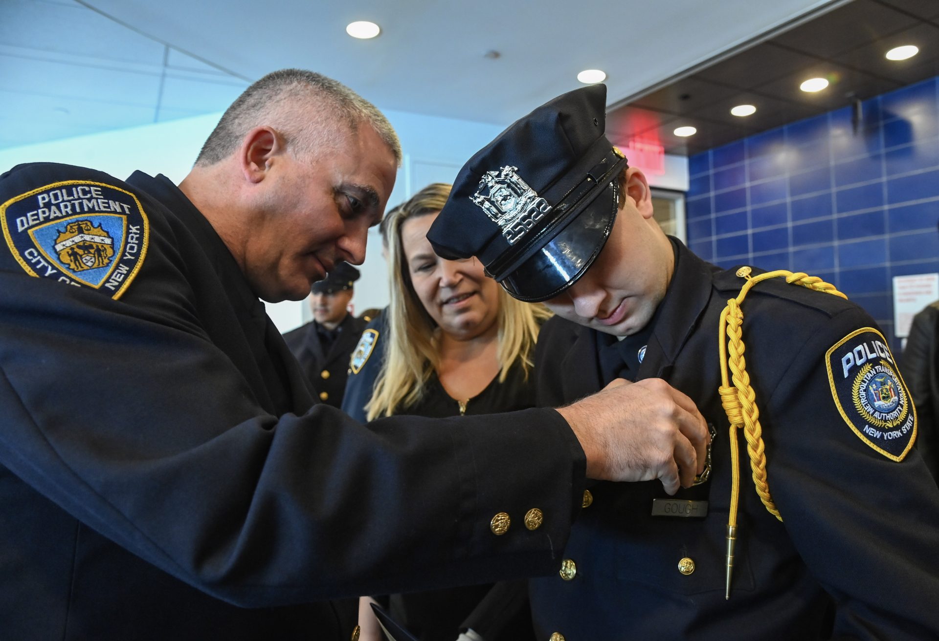 Badge pinning at an NYPD academy graduation
