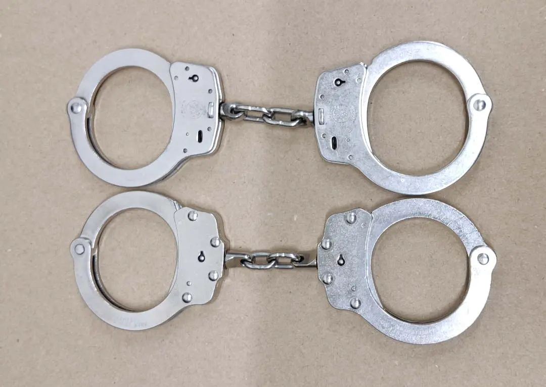 Peerless and Smith & Wesson chain handcuffs shown side by side