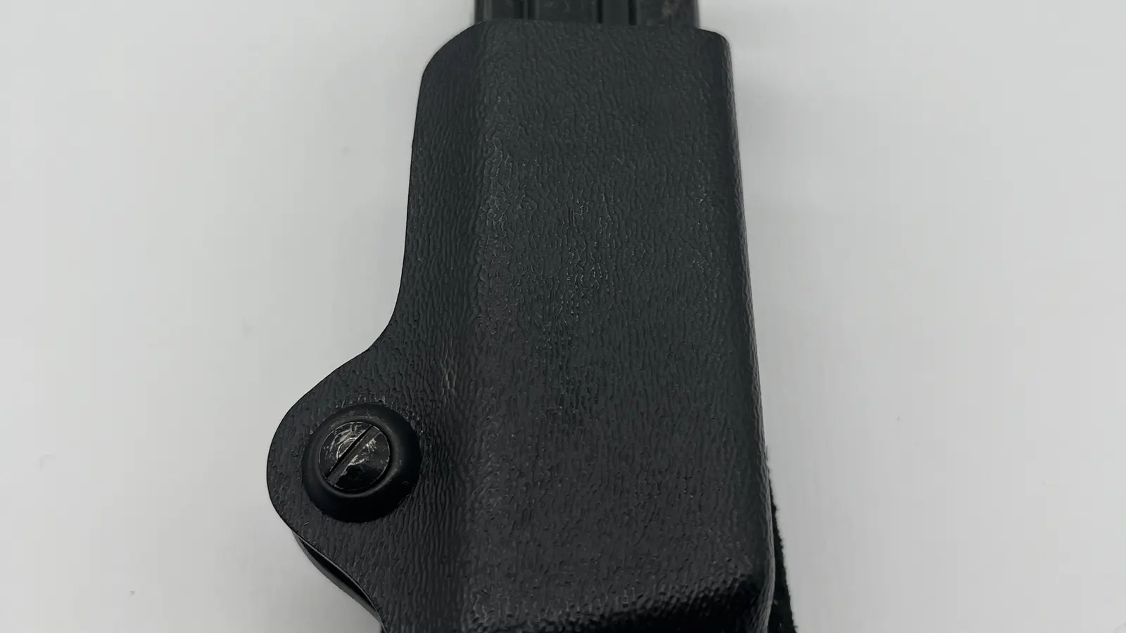 Black concealed-carry magazine holder with a pistol magazine inserted