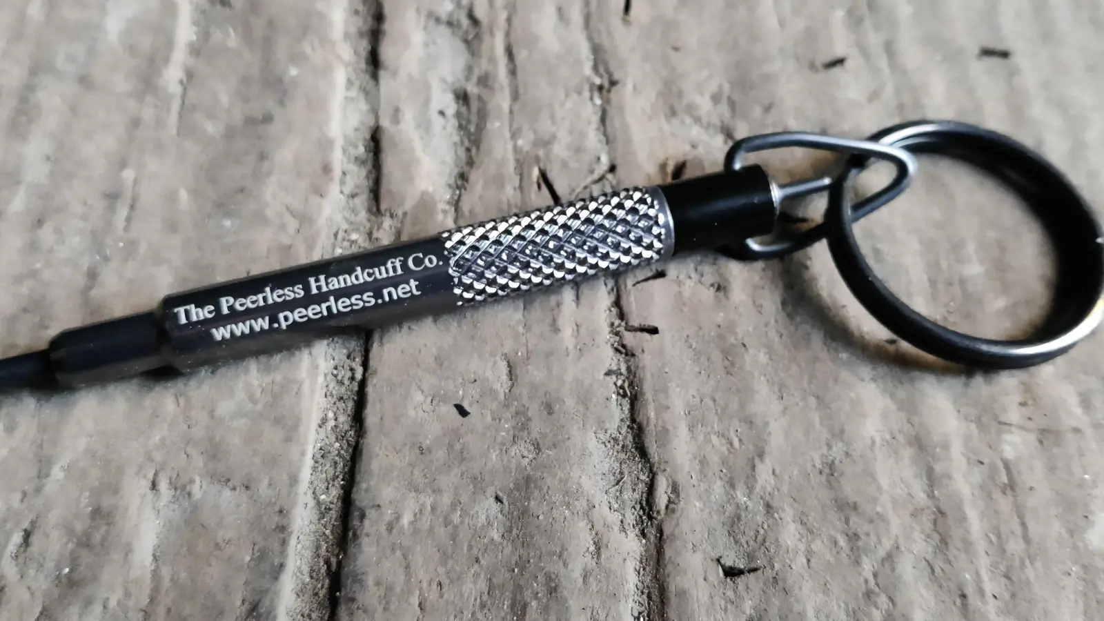 Peerless handcuff key with a textured grip and key ring